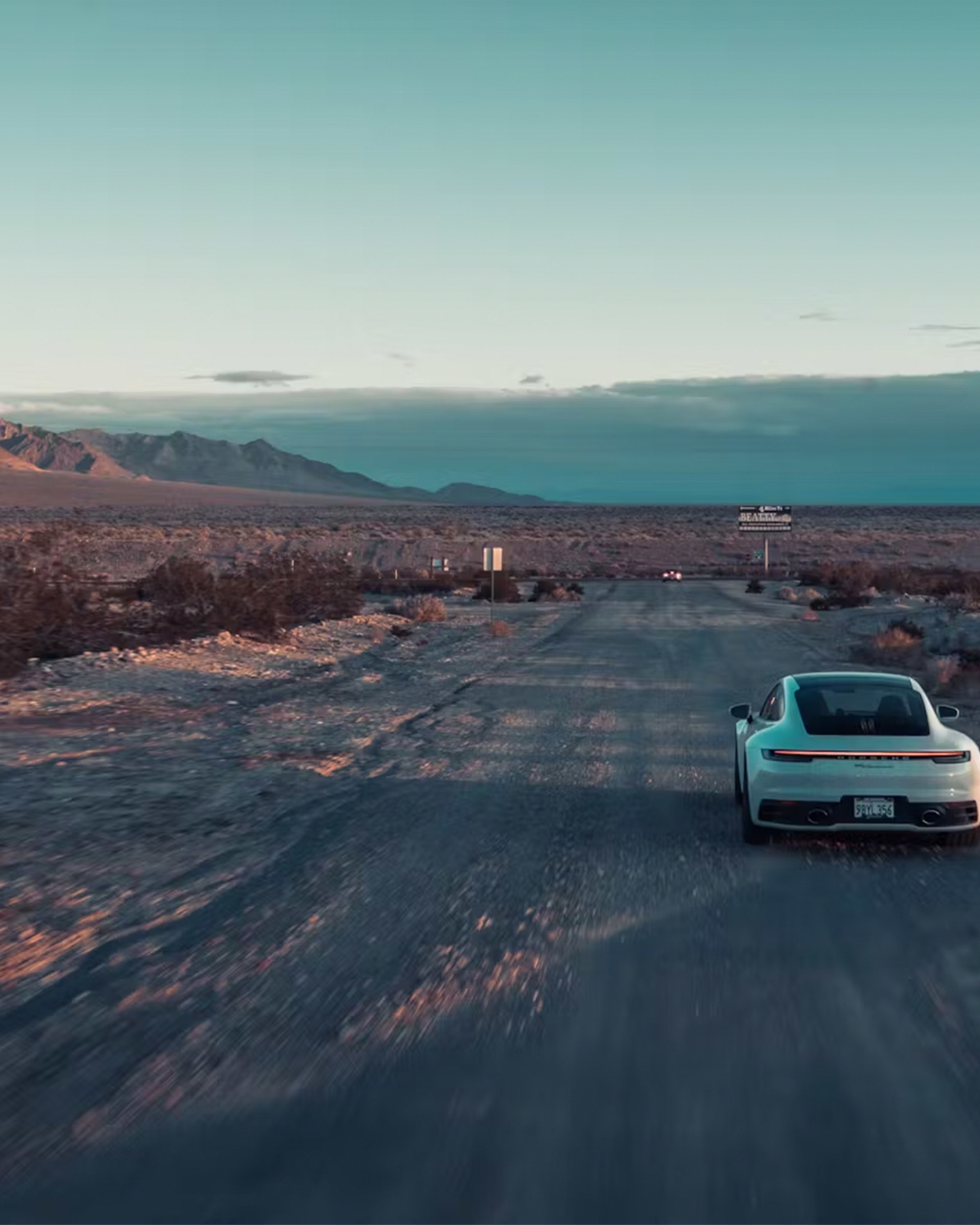 Shows Picture of A_white_Porsche_911_in_the_landscape.jpg