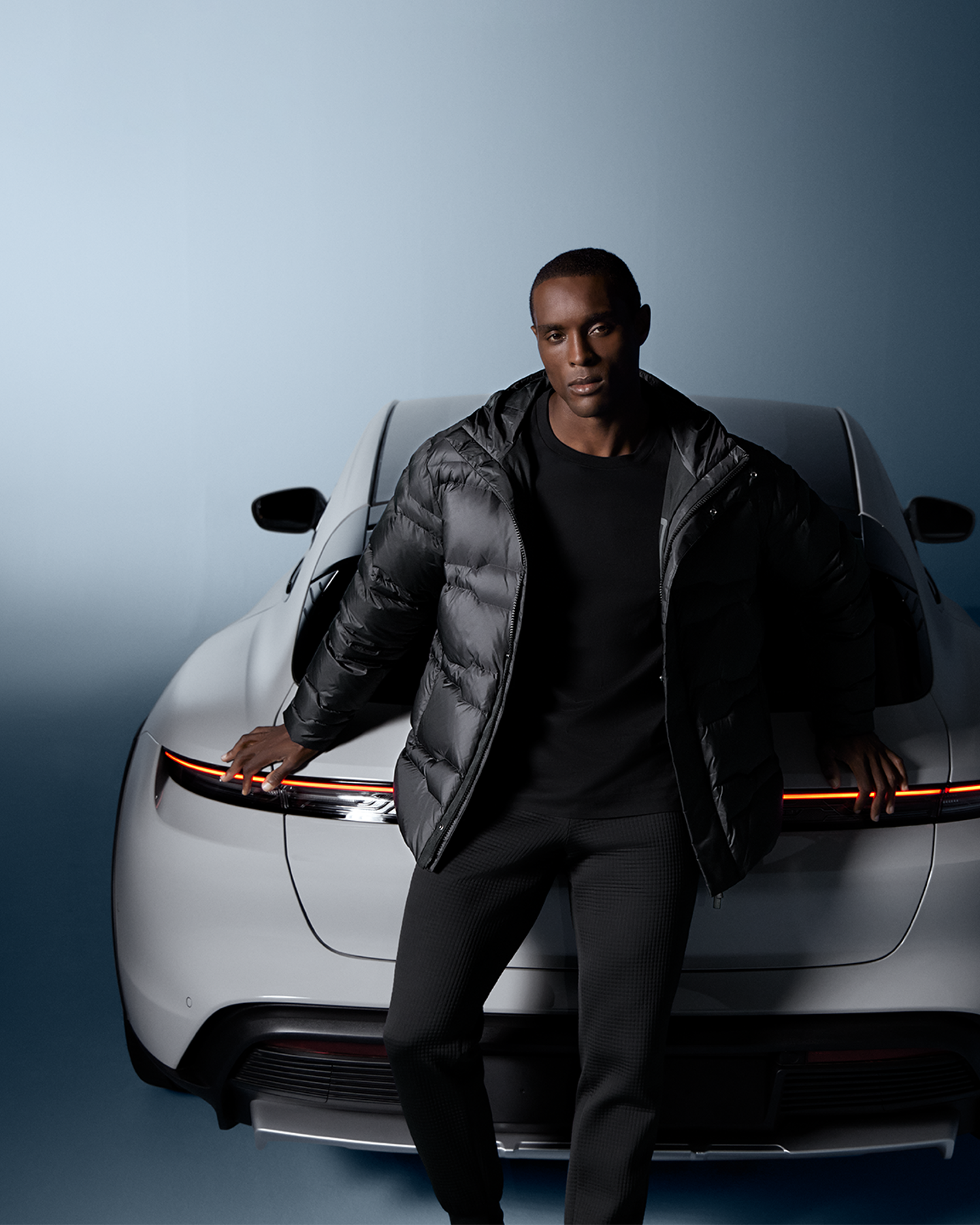 Shows Picture of pd-fashion-fw-2024-man-wearing-pd-fashion-in-front-of-porsche.png